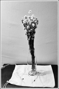 Close-up of vase on table against wall