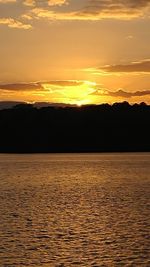 Scenic view of sea against orange sky