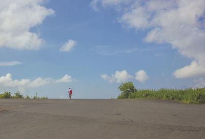 Rear view of people walking on countryside landscape