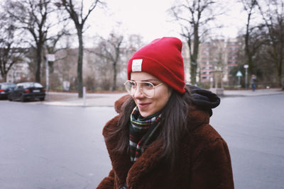 Portrait of smiling young woman standing in snow