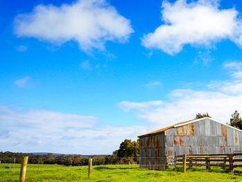 Old barn scenic view of field against sky in western australia.