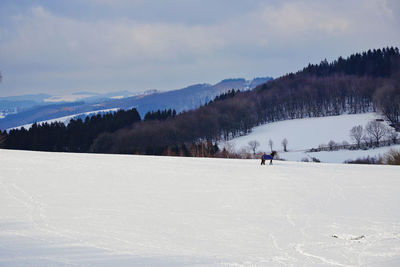 Scenic view of mountains against sky during winter