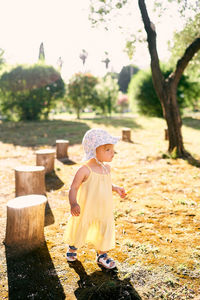 Full length of cute girl against plants