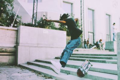 Side view of man skateboarding on wall