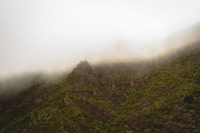 Scenic view of mountains against cloudy sky