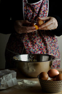 Midsection of woman preparing food on table