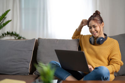 Young woman using laptop at home