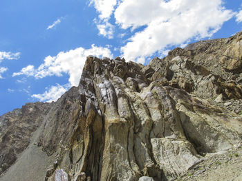 Low angle view of rocky mountains against sky