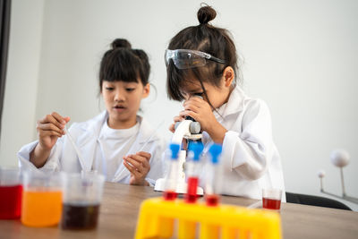 Female doctor examining chemical in laboratory