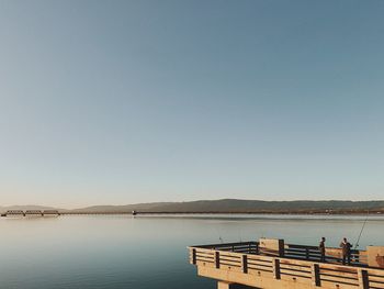 Scenic view of lake against clear blue sky