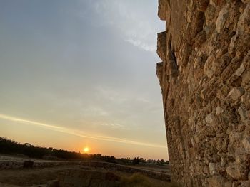 Scenic view of land against sky during sunset