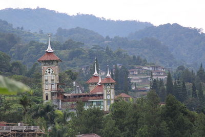 Traditional building by mountains against sky