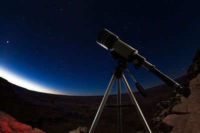 Low angle view of crane against sky at night