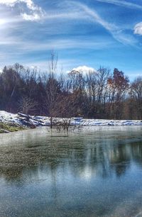 Scenic view of lake against sky during winter