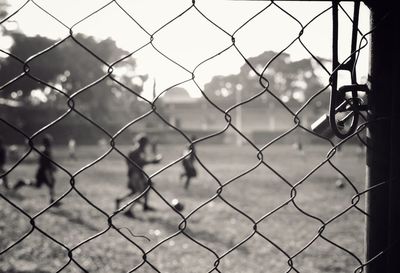 Close-up of chainlink fence against sky