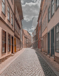 Empty alley amidst buildings in city