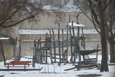 Empty chairs and tables on snowy field