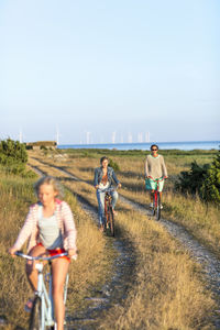 Mother with daughters cycling, oland, sweden