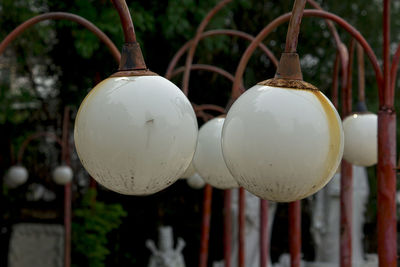 Close-up of old electric lamps hanging outdoors