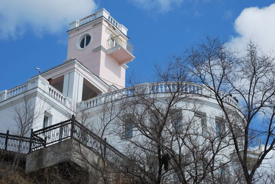 Low angle view of building and trees against sky