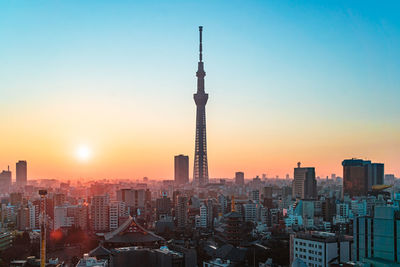 Modern buildings in city at sunset