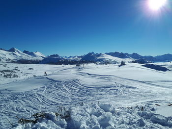 Scenic view of snowcapped mountains against clear blue sky