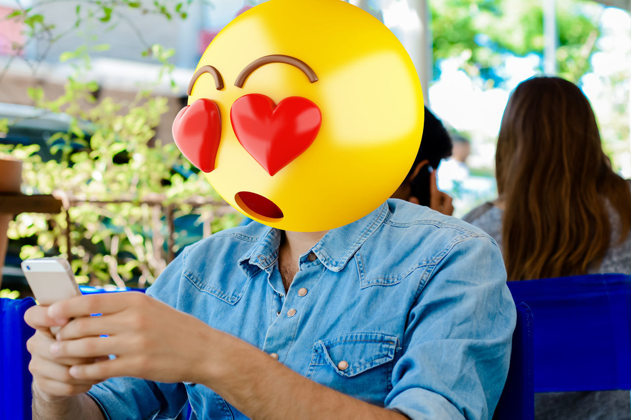 REAR VIEW OF PEOPLE WITH BALLOON ON LAPTOP