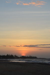 Scenic view of beach against sky during sunset