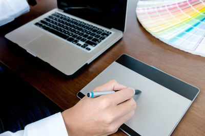 High angle view of person using laptop on table