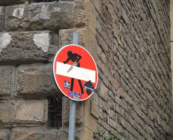 Close-up of road sign on wall