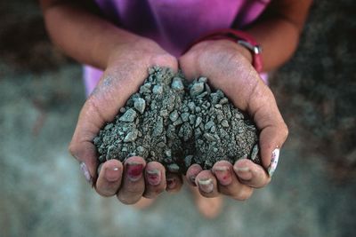 Close-up of woman holding soil