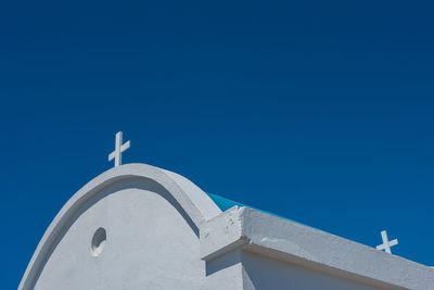 Traditional greek white chapel with a blue roof on the seaside. agioi anargyroi chapel, cyprus