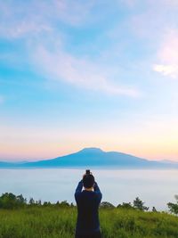 Rear view of woman standing on land