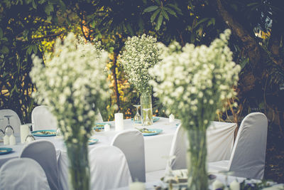 White flowers in vase on table in wedding party