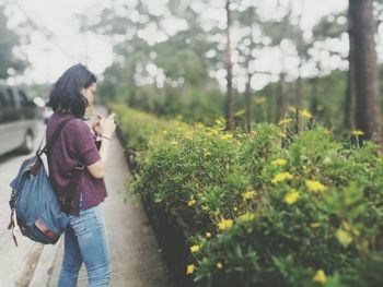 Woman with flowers on plants