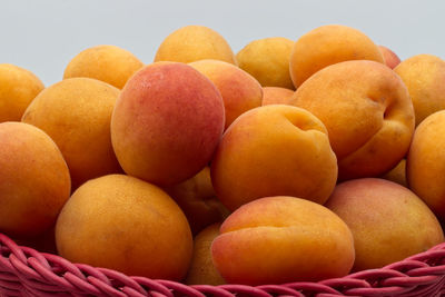 Close-up of oranges in basket for sale