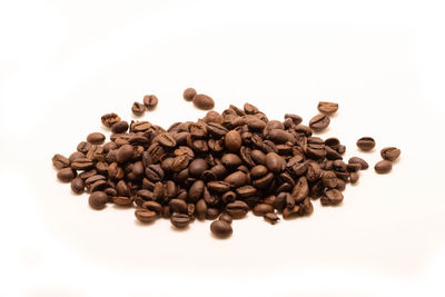 High angle view of coffee beans against white background