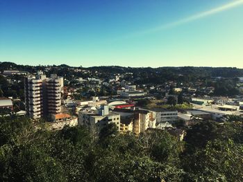 High angle view of cityscape against blue sky