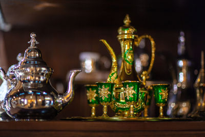 Arabian cup and teapot of gold on the eastern market. oriental tea
