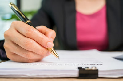 Close-up of hand holding pen