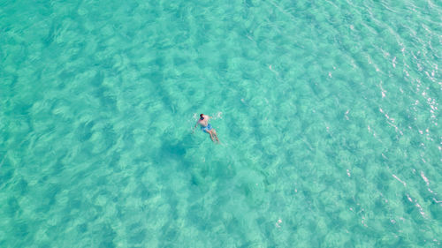 High angle view of man swimming in sea