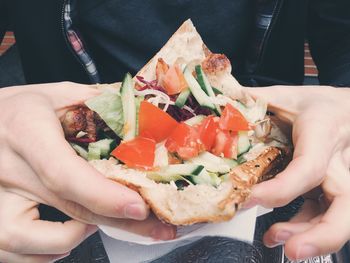 Midsection of man having kebab