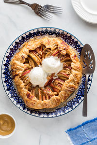 A salted caramel apple galette topped with ice cream, ready for serving.