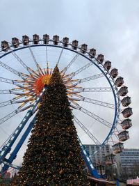 Low angle view of ferris wheel against sky
