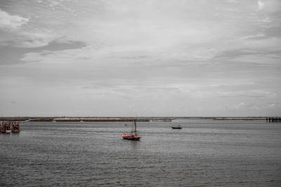 Boat sailing in sea against sky