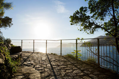 Railing by sea against sky