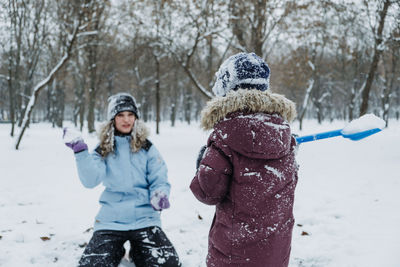 Outdoor winter activities for kids and family. let it snow. happy family mom and kid boy having fun