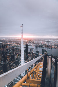 High angle view of city lit up against sky