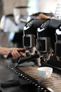 Hand holding coffee cup at cafe