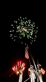 Low angle view of firework display at night